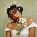 bride wearing full glam makeup, a flower crown, and holding white flowers
