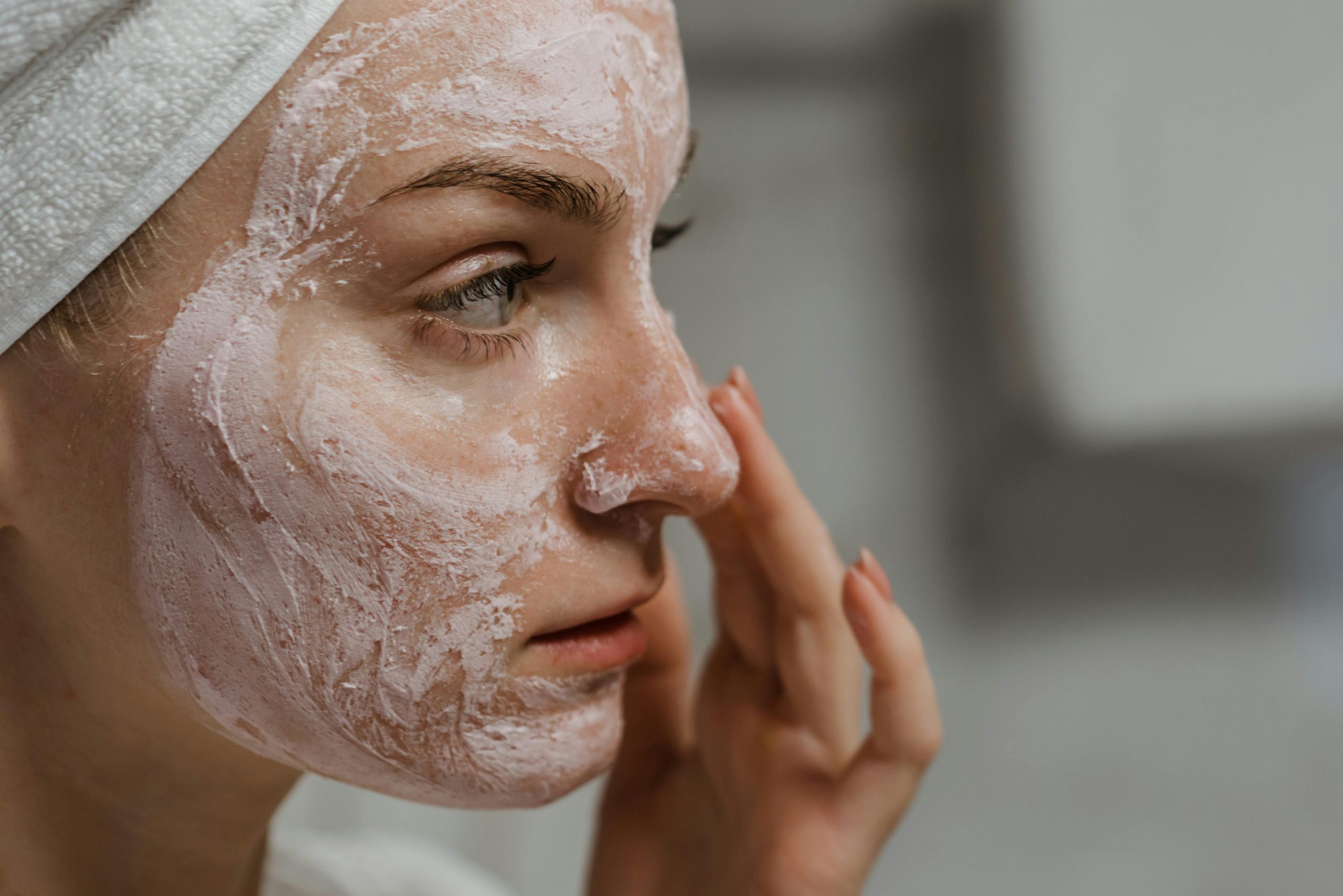 woman applying facial scrub to her face